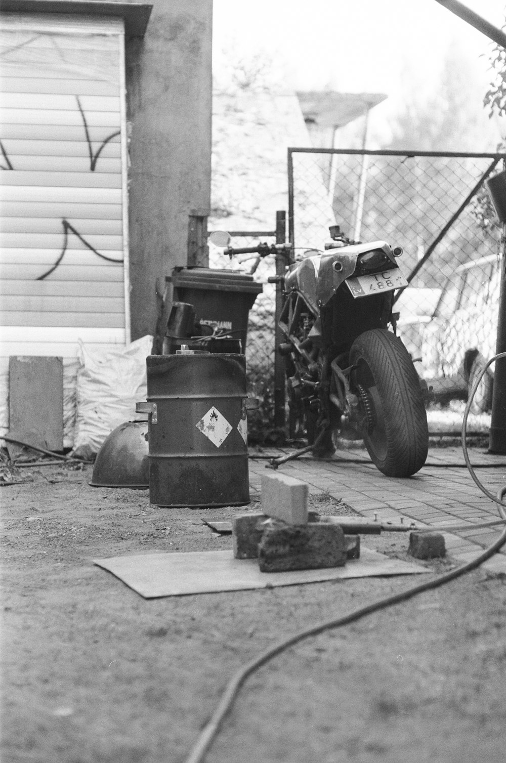 a black and white photo of a motorcycle on the ground