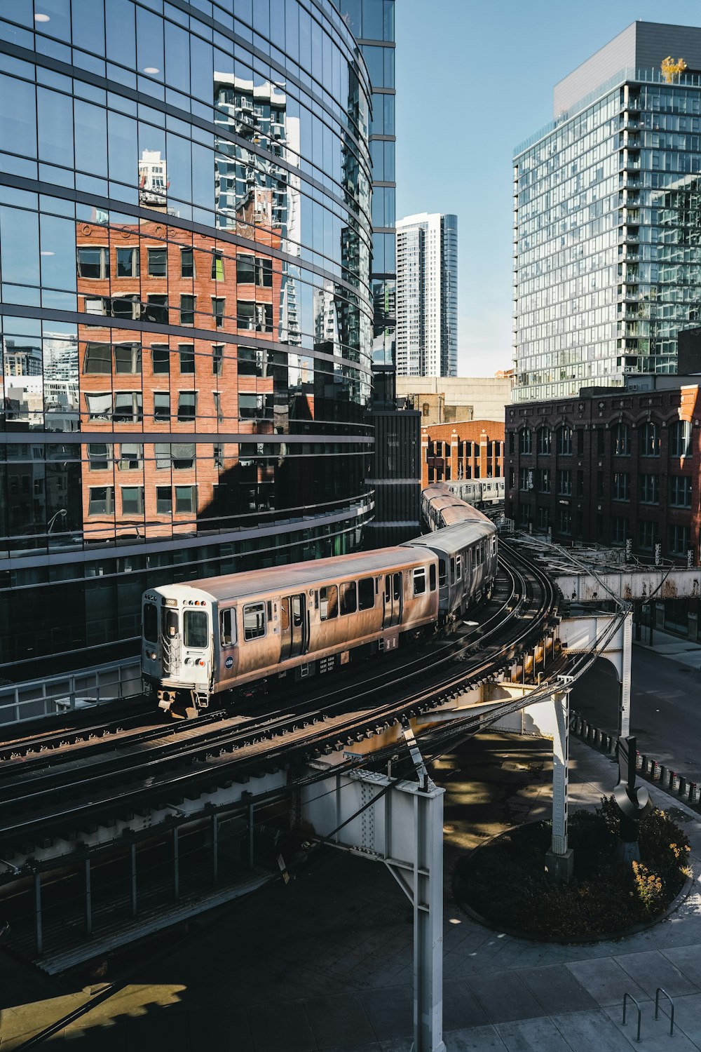 a train traveling through a city next to tall buildings