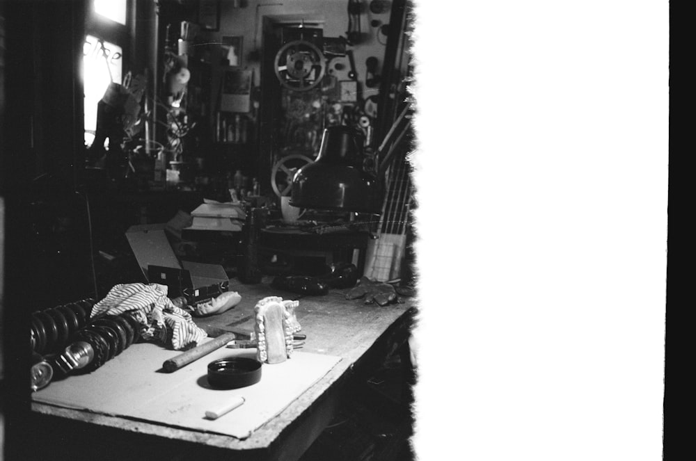 a black and white photo of a table with a guitar