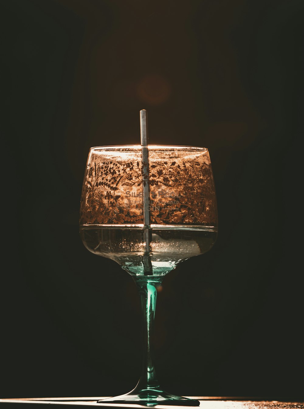 a wine glass sitting on top of a table