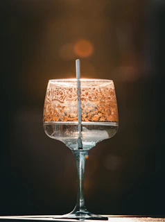 Close-up of a custom-printed glass with a delicate floral design glowing softly in warm light