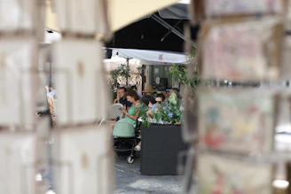 A group of people enjoying a Mintiva-powered Android device at a sunny outdoor café.
