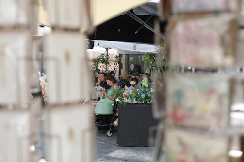 A group of people enjoying a Mintiva-powered Android device at a sunny outdoor café.