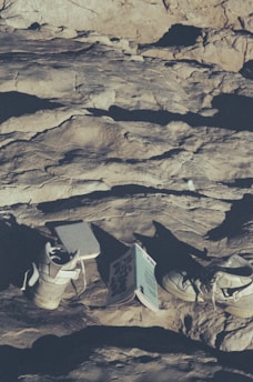 An open ebook on a running track, surrounded by running shoes and a water bottle.