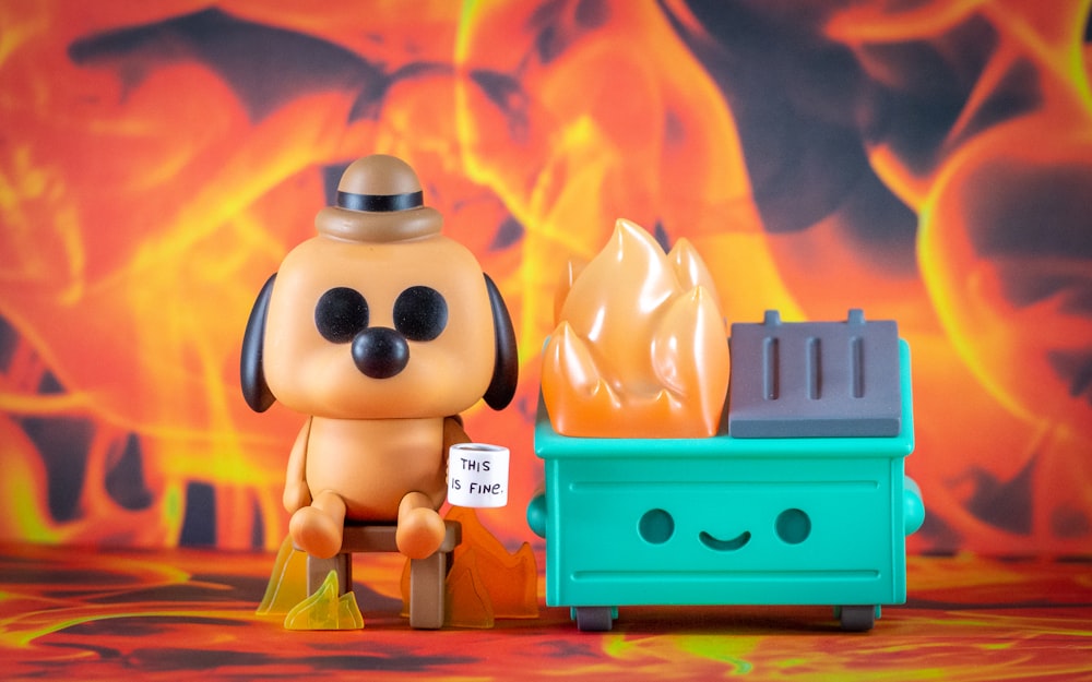 a small toy dog sitting next to a fire