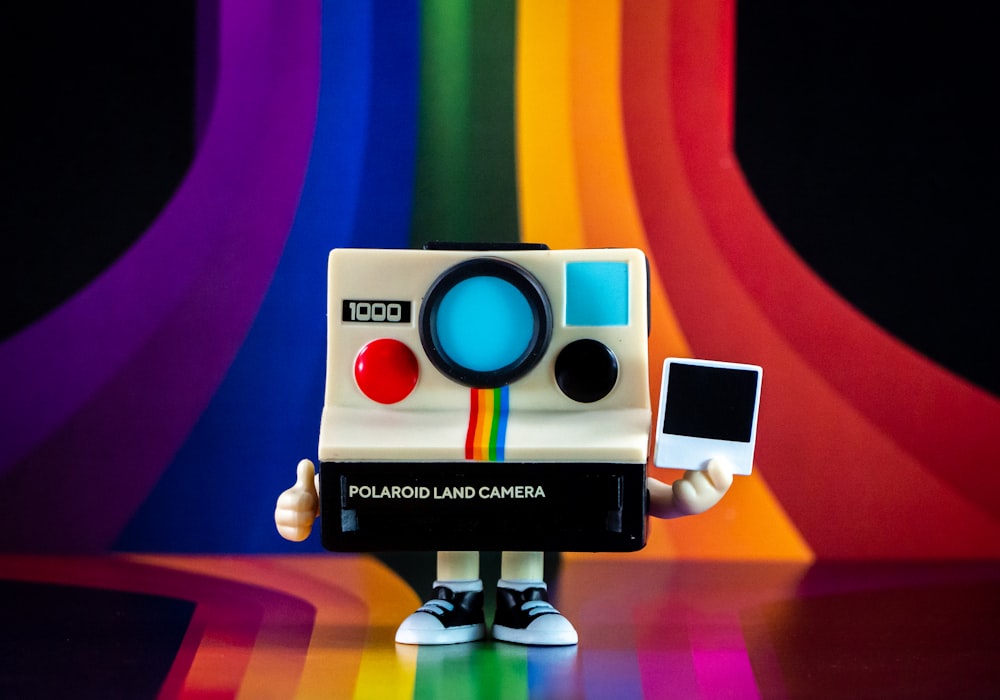 a polaroid camera with a rainbow background