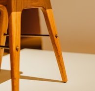 Close-up of elegant chair legs highlighting fine woodwork details.