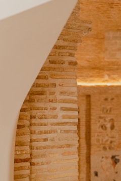 Detail of textured wall and elegant architectural lines in warm tones.