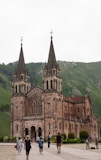 a group of people walking in front of a church