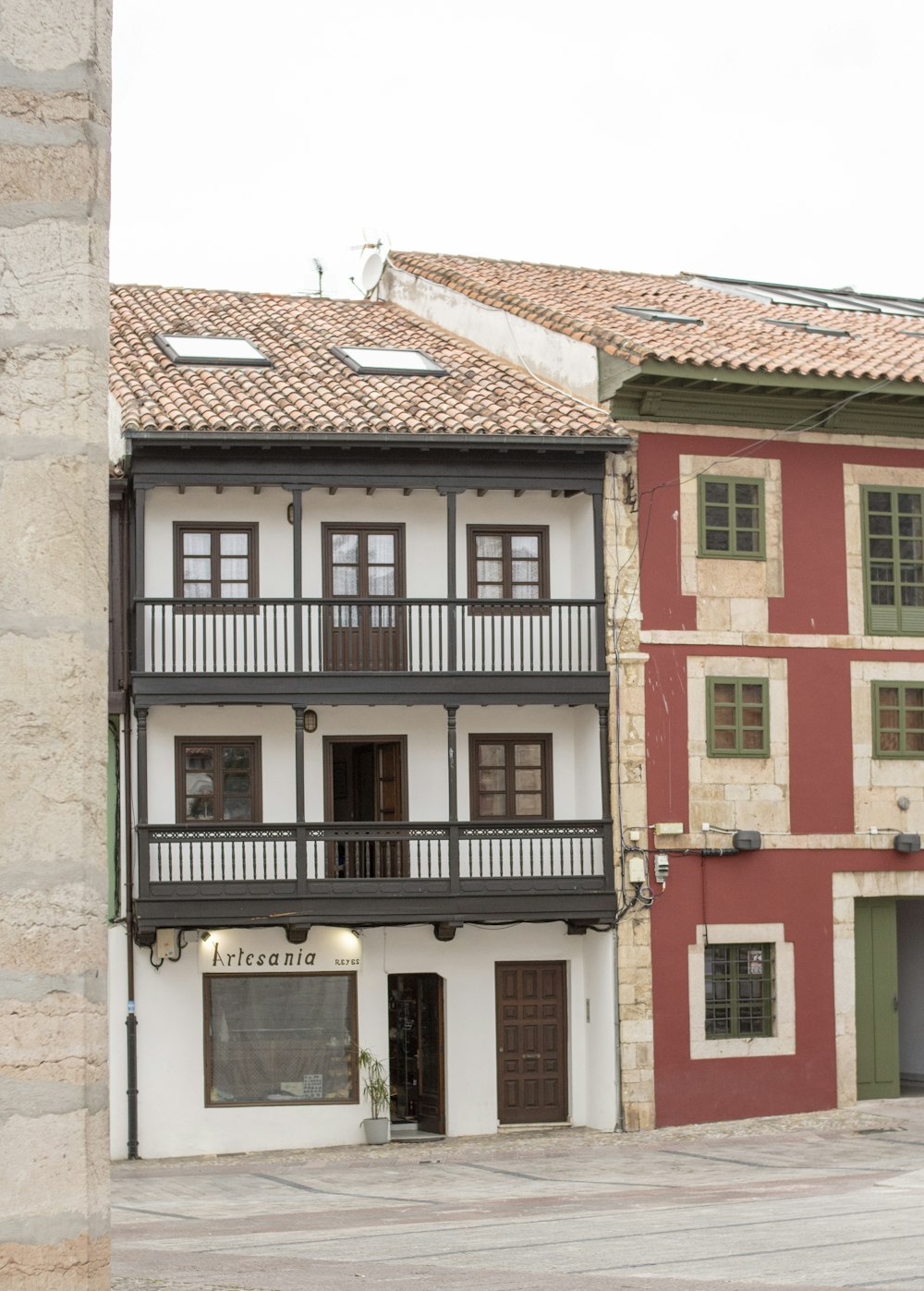 a red and white building sitting next to a tall brick building