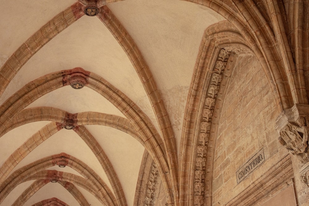the ceiling of a large cathedral with stone arches