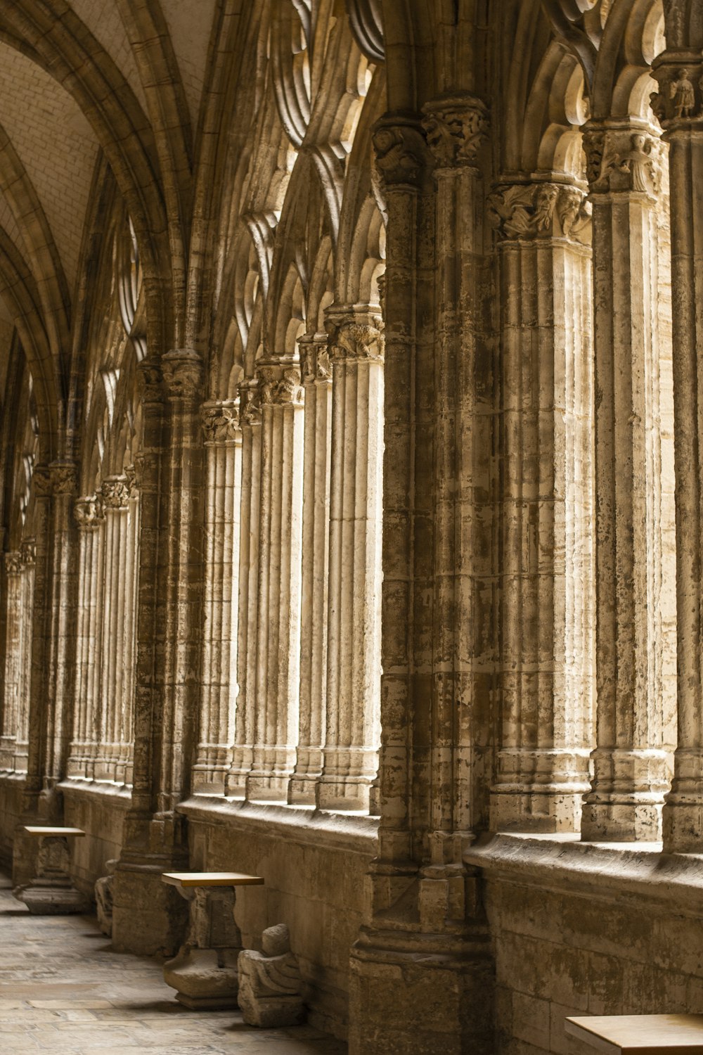 a long row of stone pillars in a building