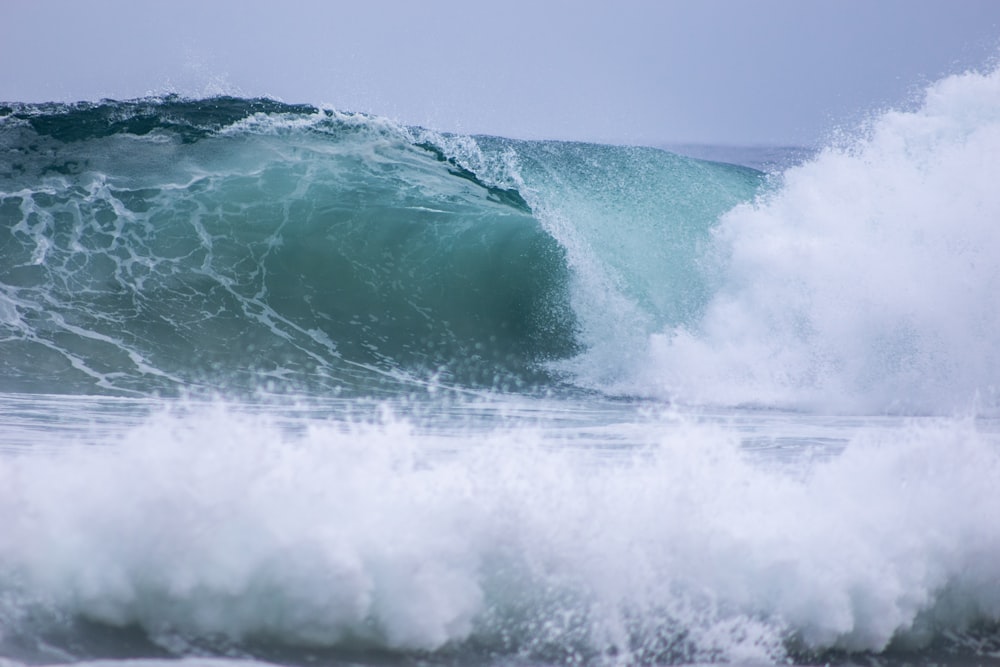 a person riding a surfboard on a wave in the ocean