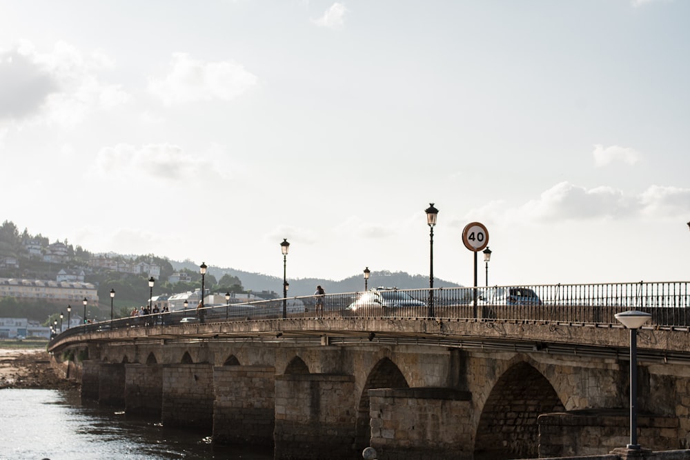 a bridge over a body of water with a clock on it