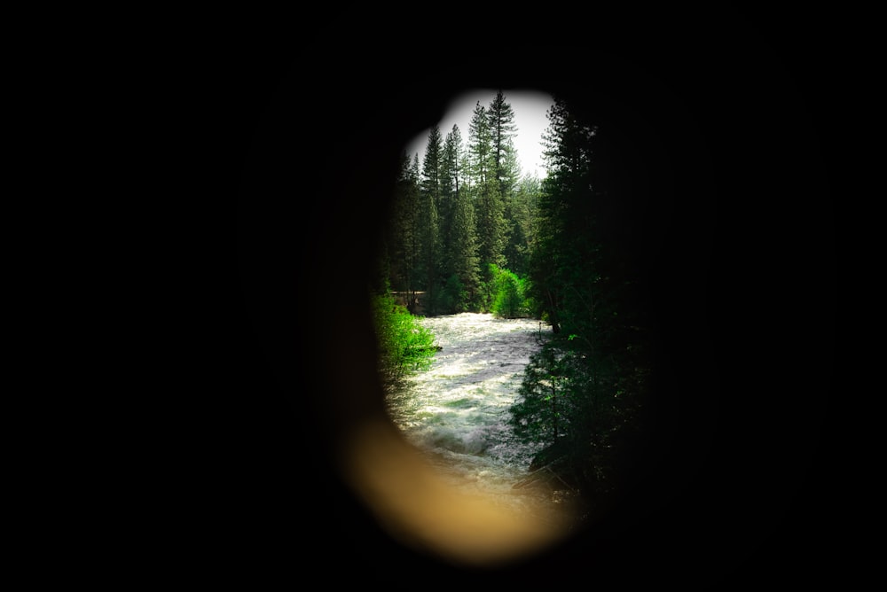 a view of a river through a hole in a wall