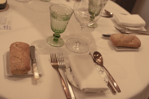 Illustration of proper table manners with place settings and polite gestures.