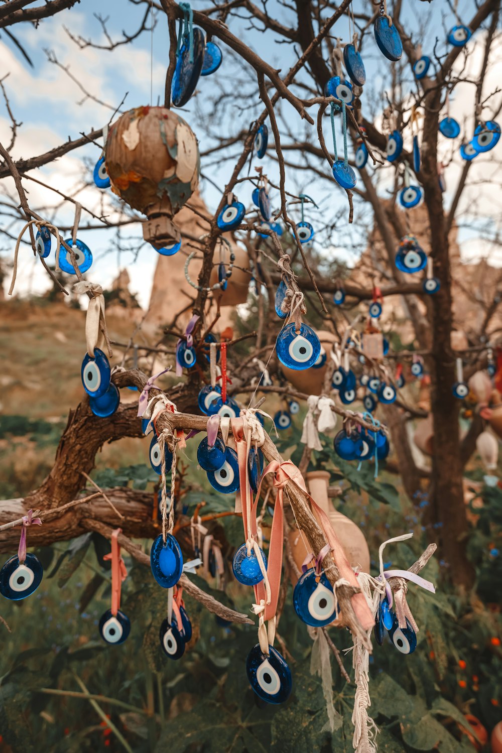 a tree with blue and white ornaments hanging from it's branches