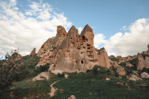 a rock formation in the middle of a field