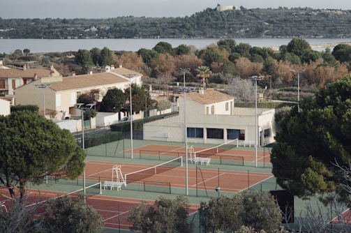 A scenic view of a tennis facility surrounded by greenery.