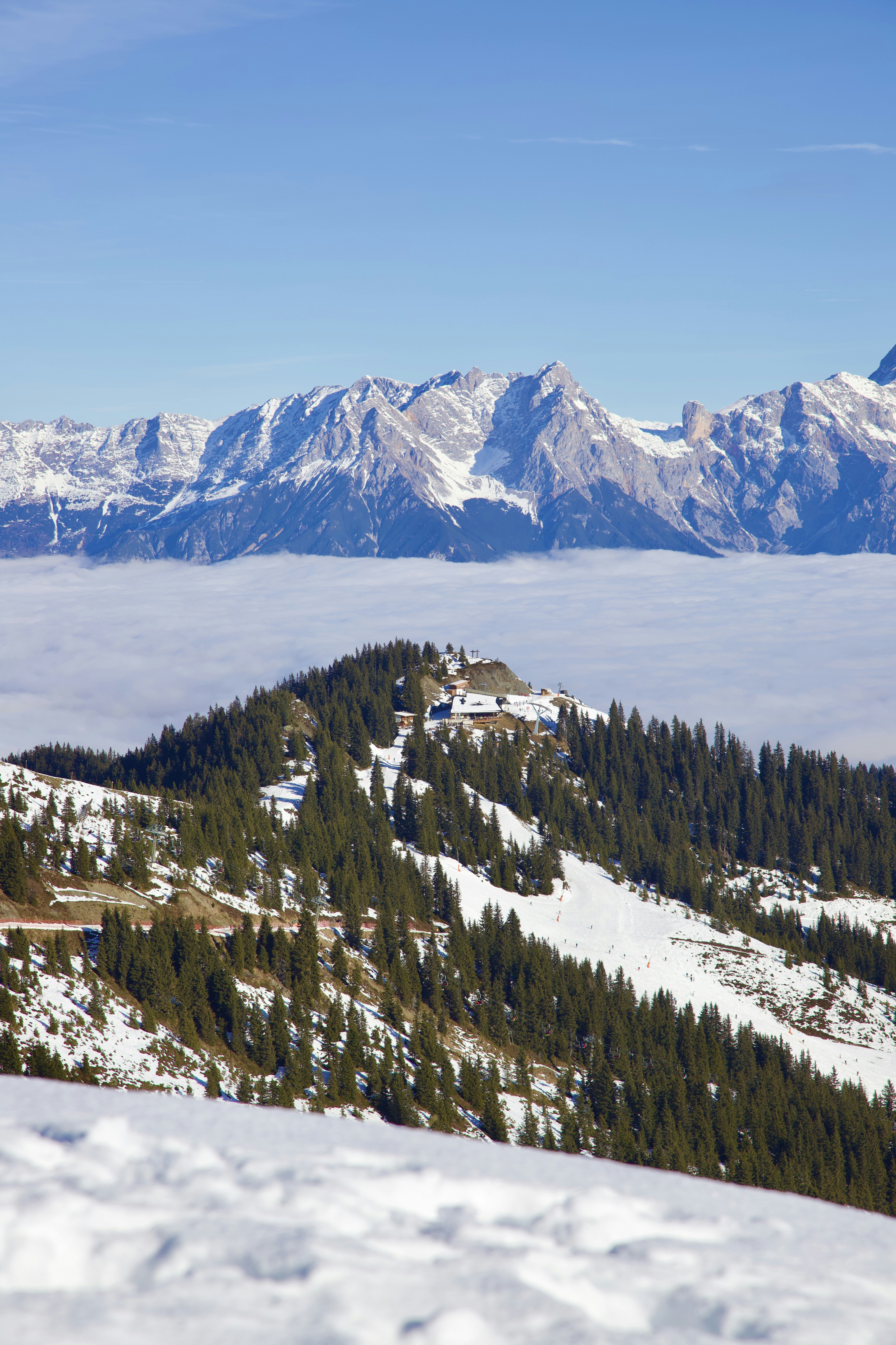 a view of a mountain range with snow on the ground