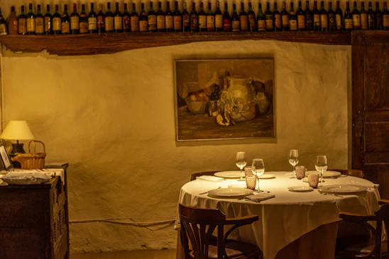 A warm, inviting dining table set for a small group, glowing softly under ambient lighting.