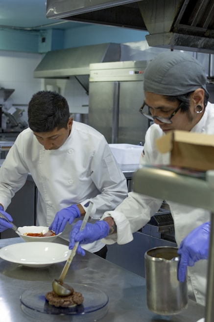 A team of chefs preparing dishes in a modern kitchen.