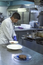 A chef preparing gourmet food in a modern kitchen.
