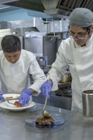 Hands preparing healthy meals in a professional kitchen environment.