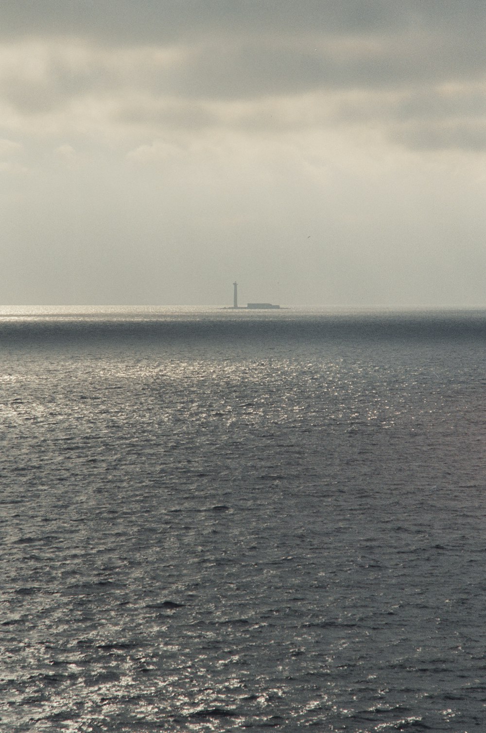 a large body of water under a cloudy sky