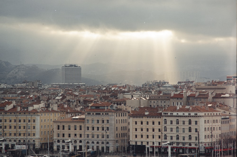 the sun shines through the clouds over a city