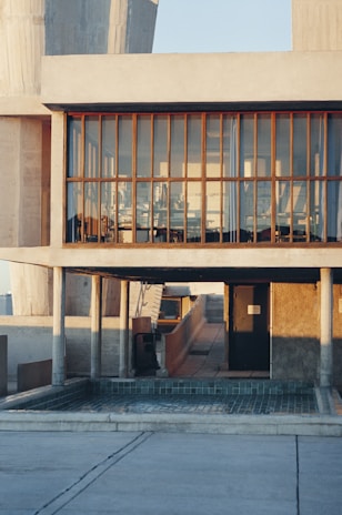 A sleek modern office building owned by lev25, bathed in warm afternoon light.