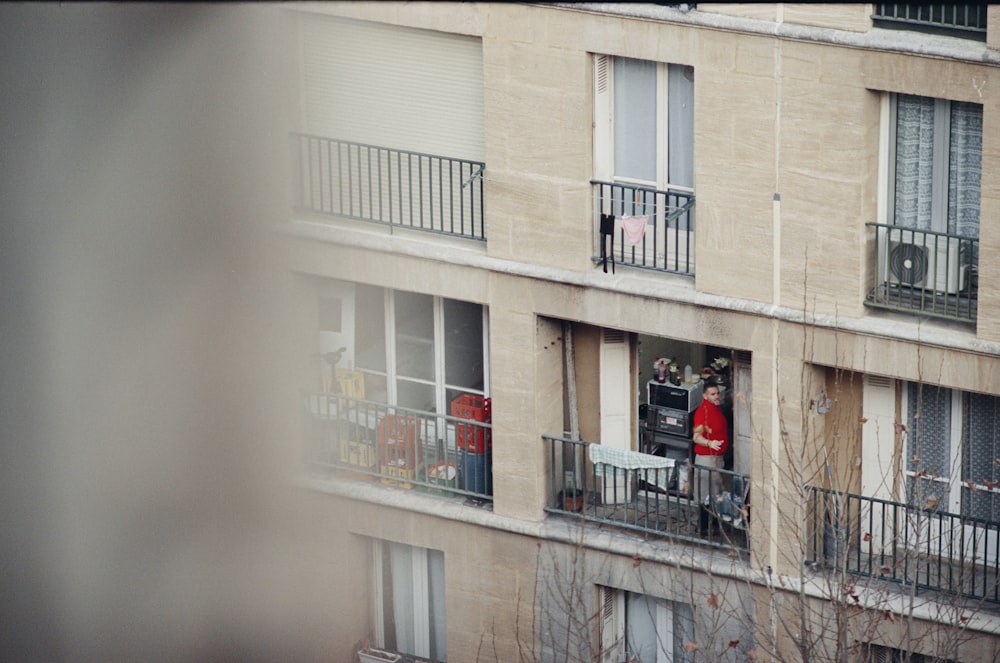 a person standing on a balcony of a building