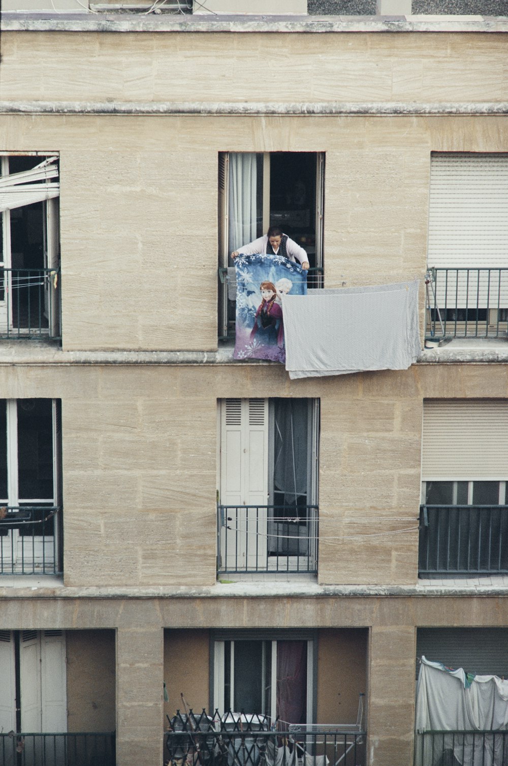 a man standing in a window of a building