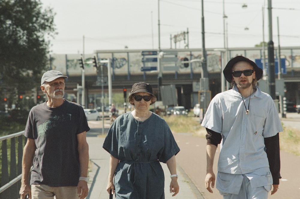 a group of people walking down a sidewalk