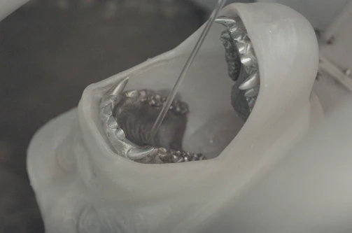 Close-up of a fiberglass sculpture being crafted in a workshop.