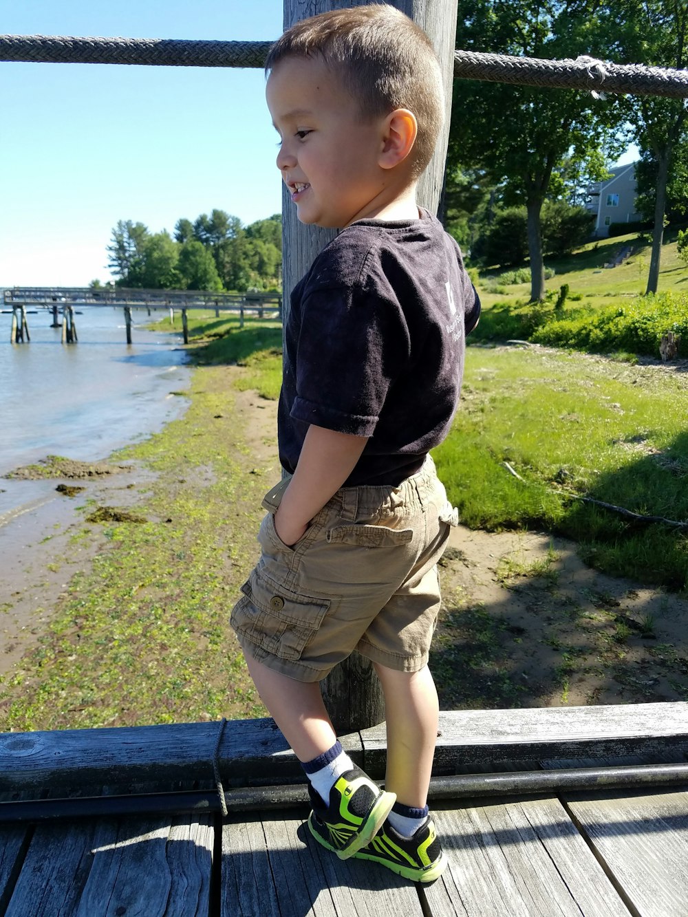 a little boy that is standing on a dock