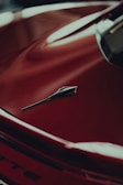 a close up of the hood of a red car