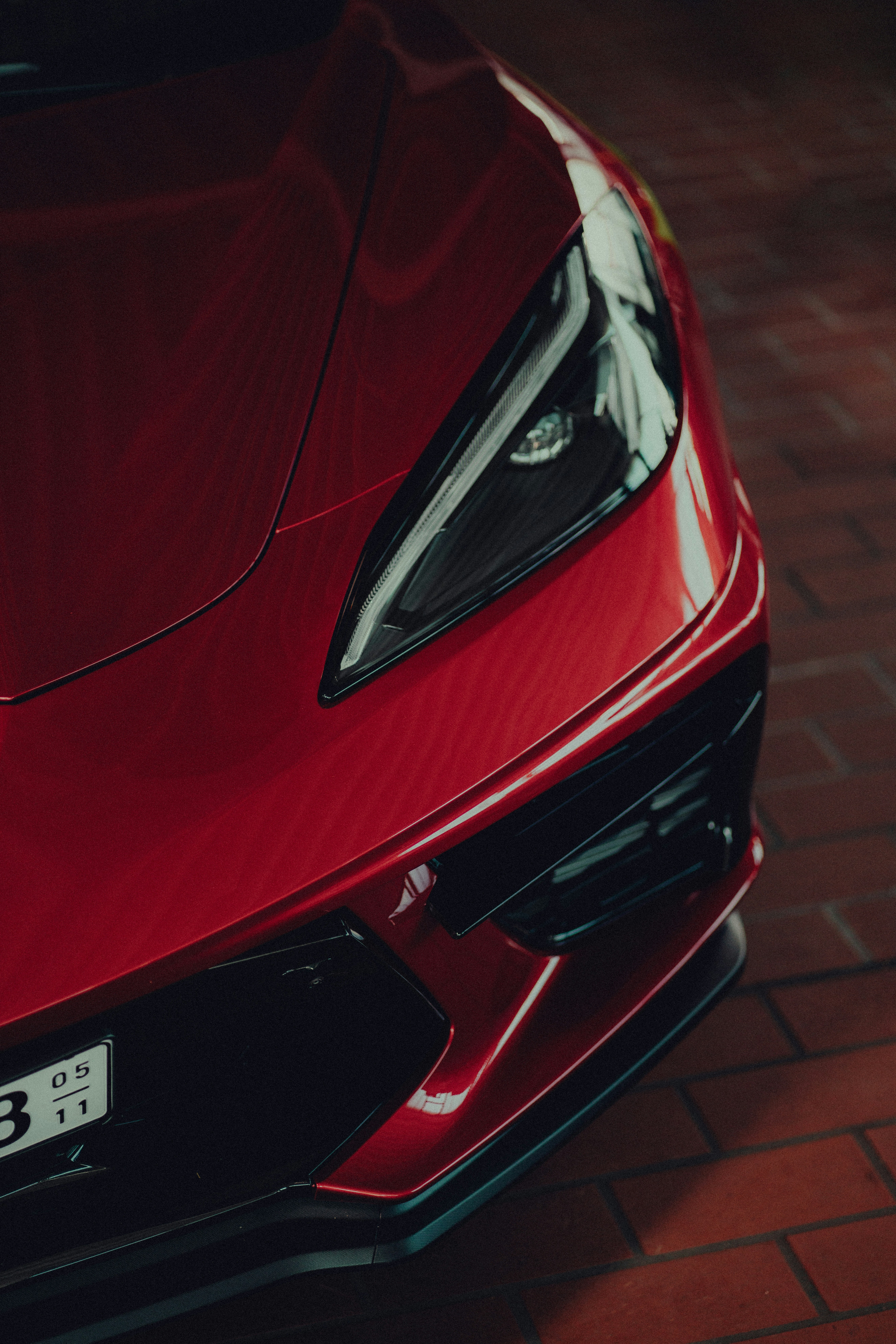 a close up of the front of a red sports car