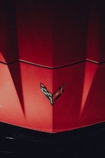 a close up of the hood of a red car