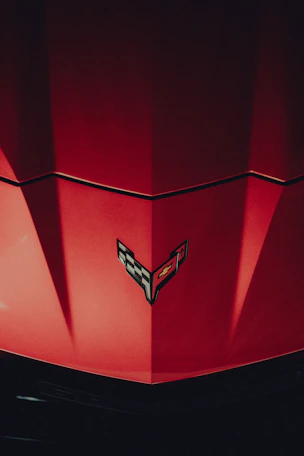 a close up of the hood of a red car