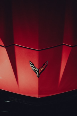 a close up of the hood of a red car