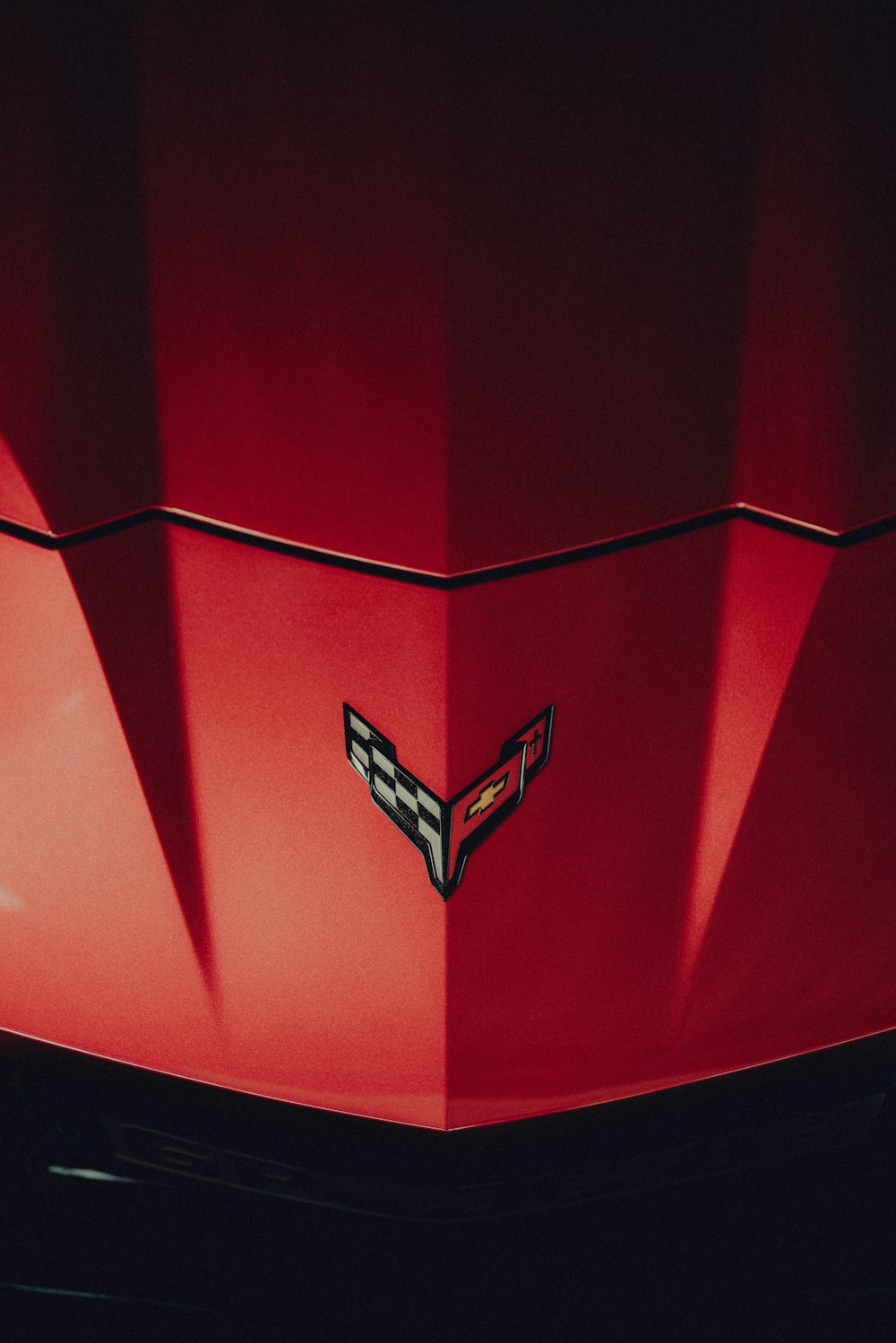 a close up of the hood of a red car