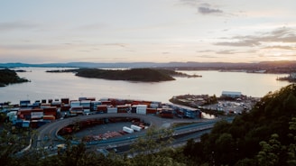 A scenic view of a shipping container yard at sunset.