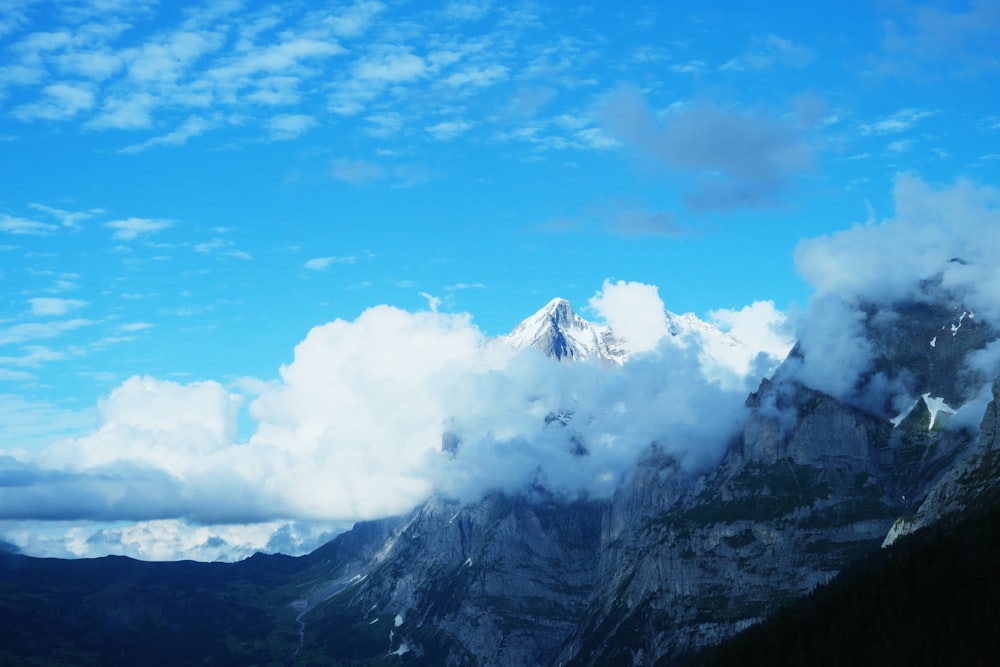 a view of a mountain range with clouds in the sky