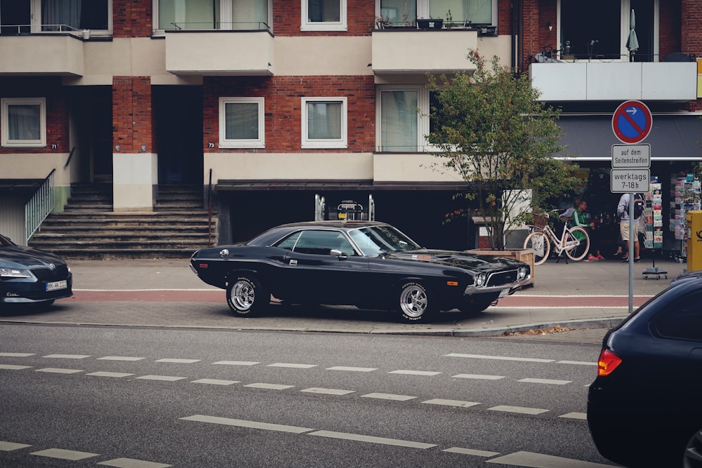 a black car parked on the side of the road