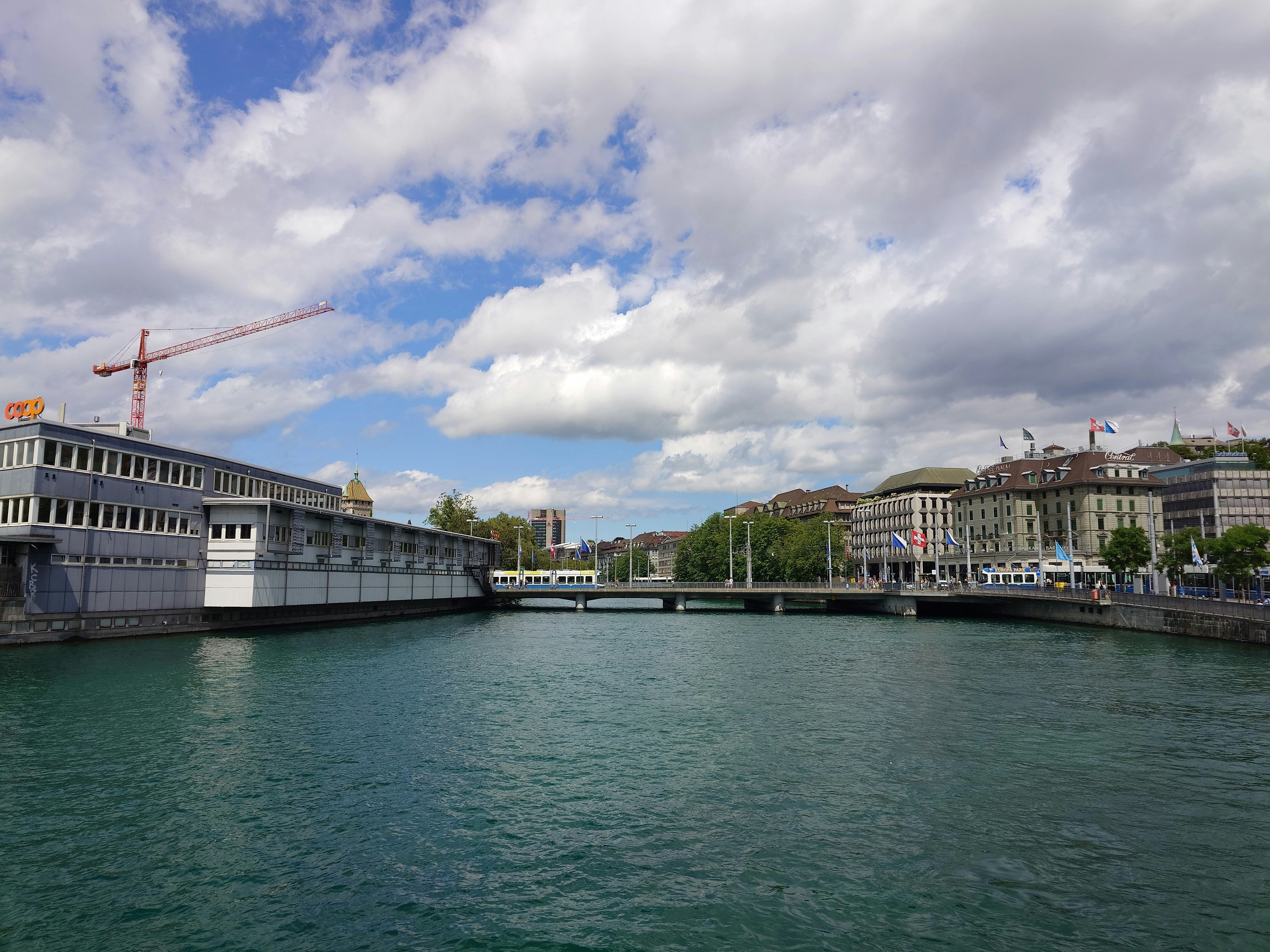 a bridge over a body of water with buildings in the background