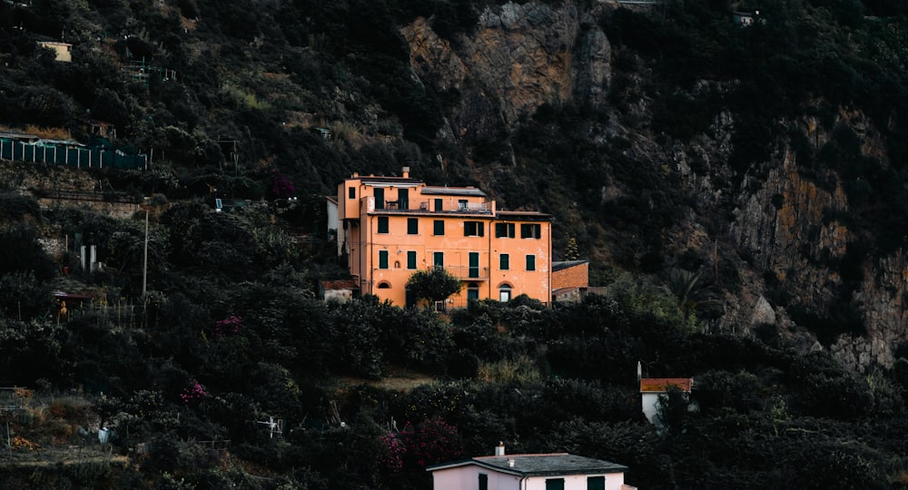 a house on a hill with a mountain in the background