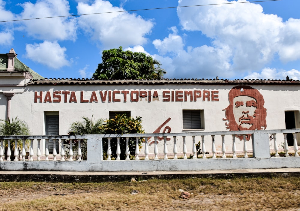 a white building with a painting of a man on it