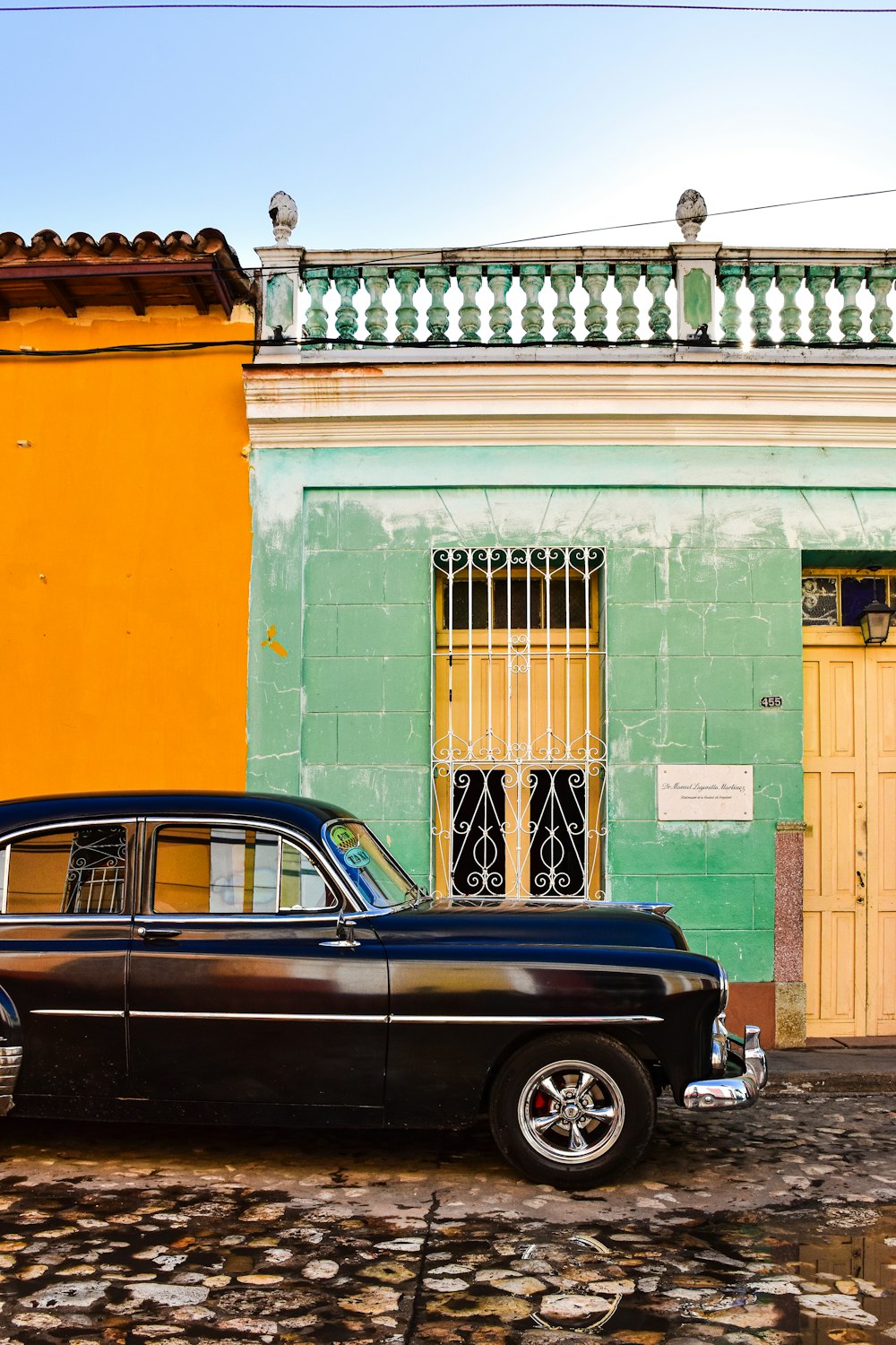 a classic car parked in front of a building