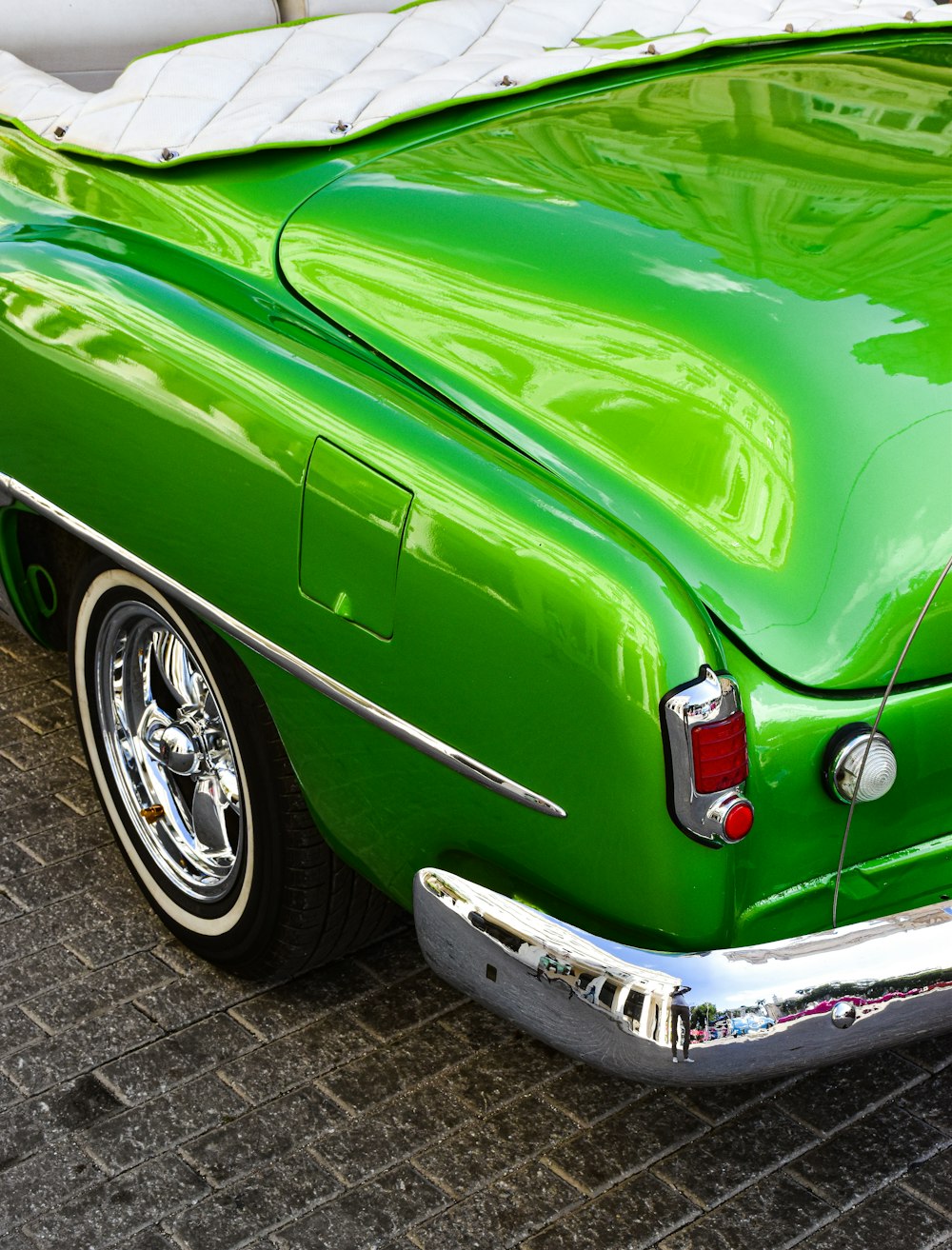 a green car parked on the side of the road